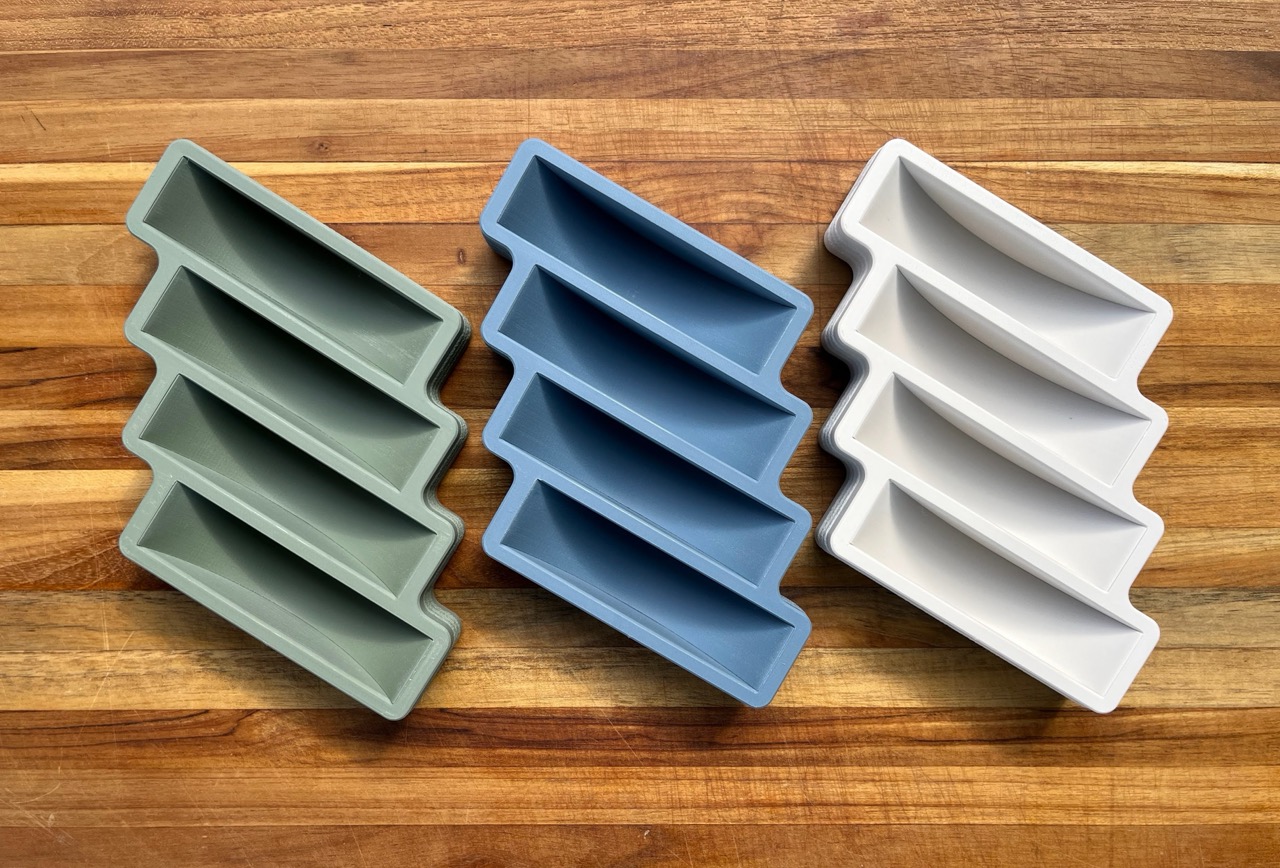 Color-matched display stand holding four topograffs